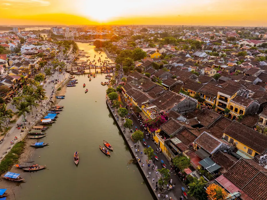 Aerial view of the old town of Hoi An over the Thu Bồn river in low sunlight
