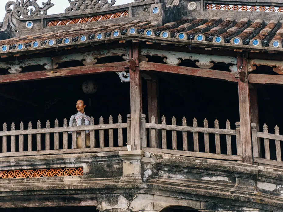 The Japanese covered bridge of Hoi An seen from the water, with the porcelain discs along the eaves