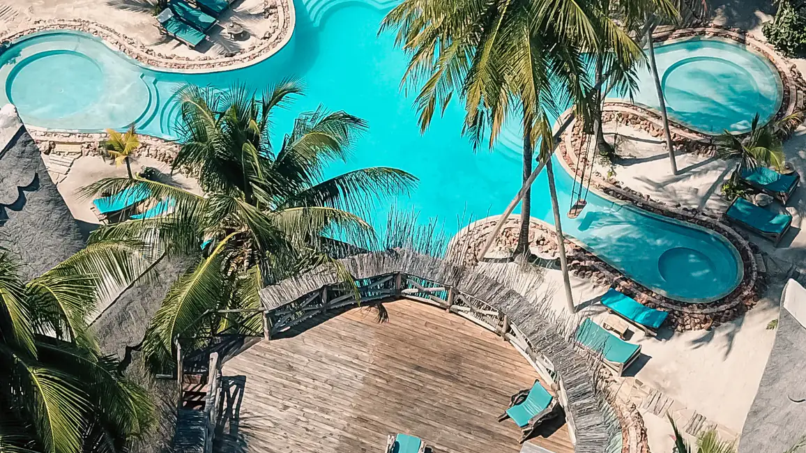Cenital de dron sobre las piscinas lobuladas de The Nest y la plataforma circular junto al agua