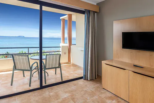 A refurbished room at the Royal Mónica, the television unit to the right and light coming in through the sliding door
