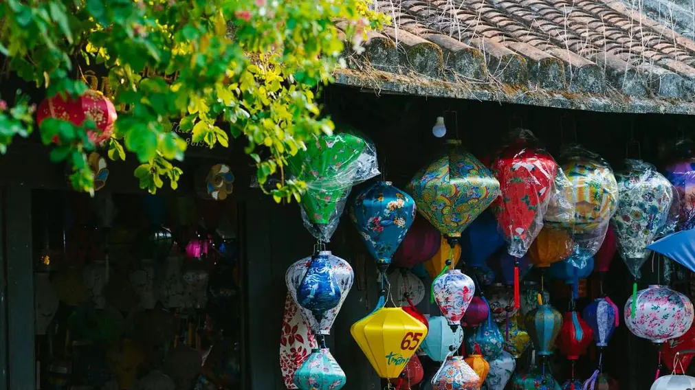 Coloured silk lanterns hanging from an eave in Hội An